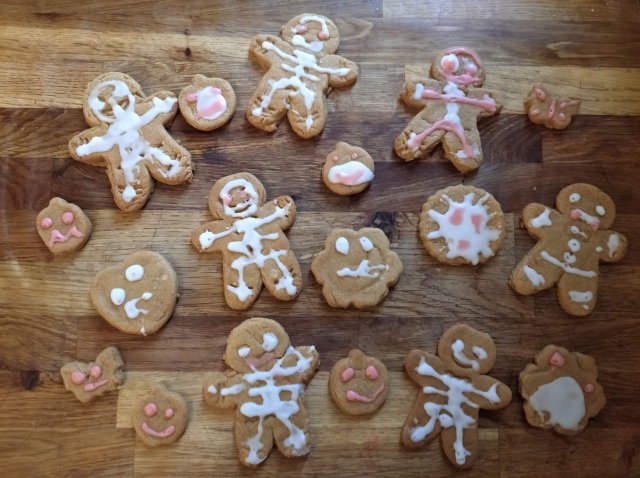 Halloween gingerbread men and biscuits iced by a child