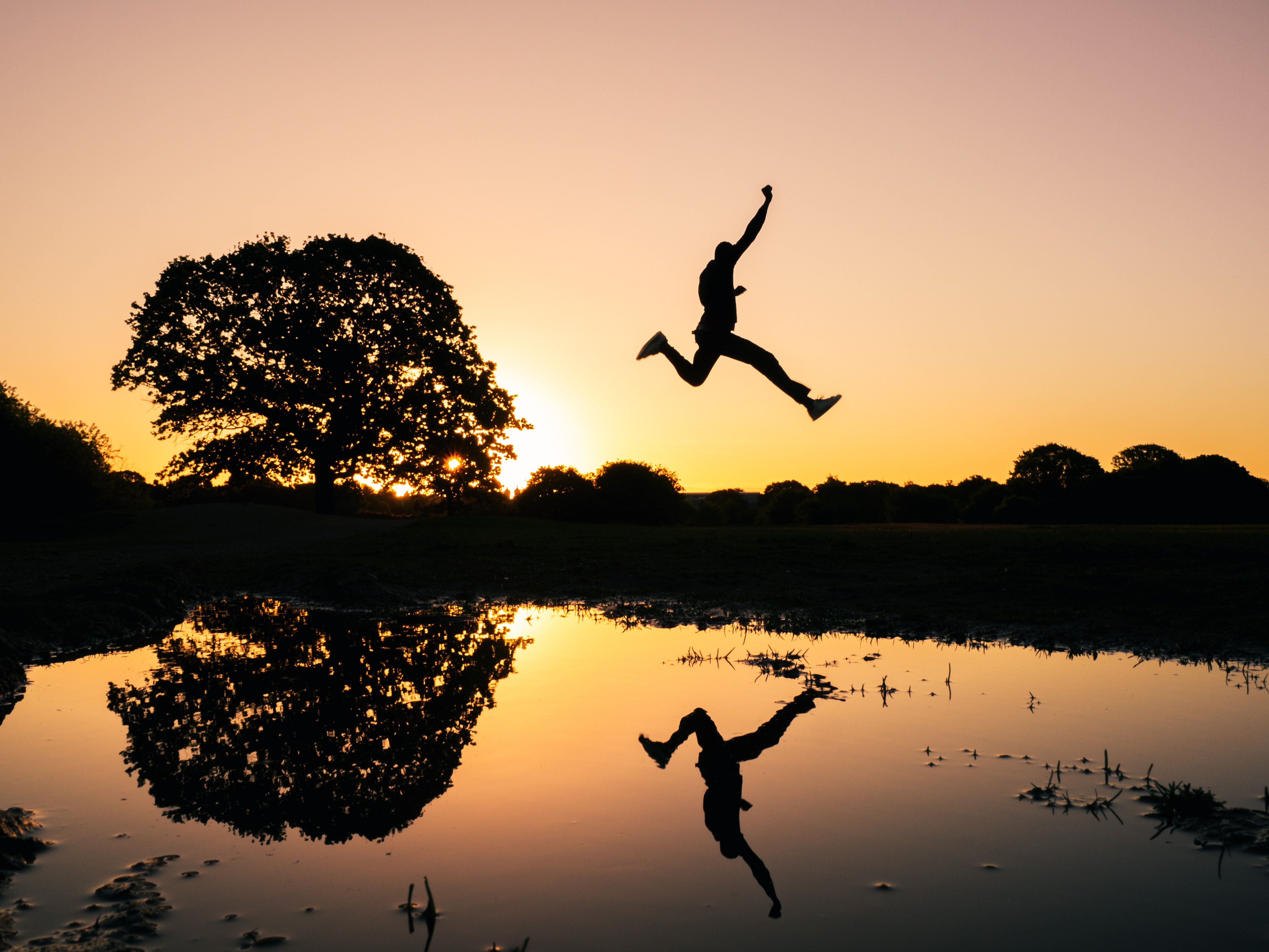 figure leaping across a lake